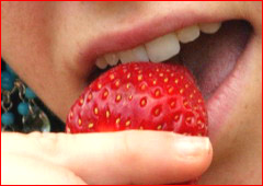 Kandie eats a strawberry